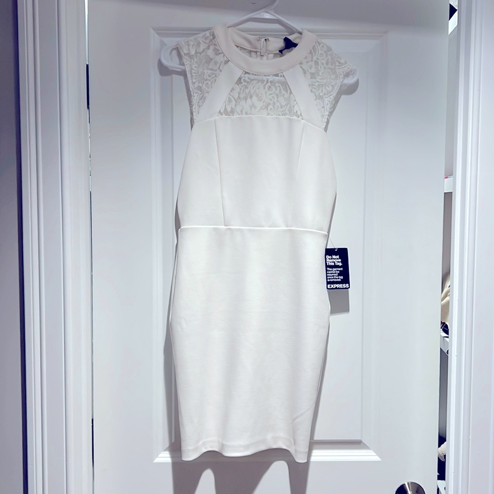 Fitted white mini dress with lace cut outs.  Tags still on it!